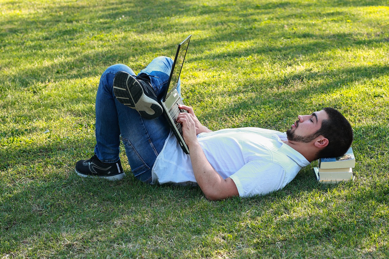 Person using a laptop to book a farm stay experience online