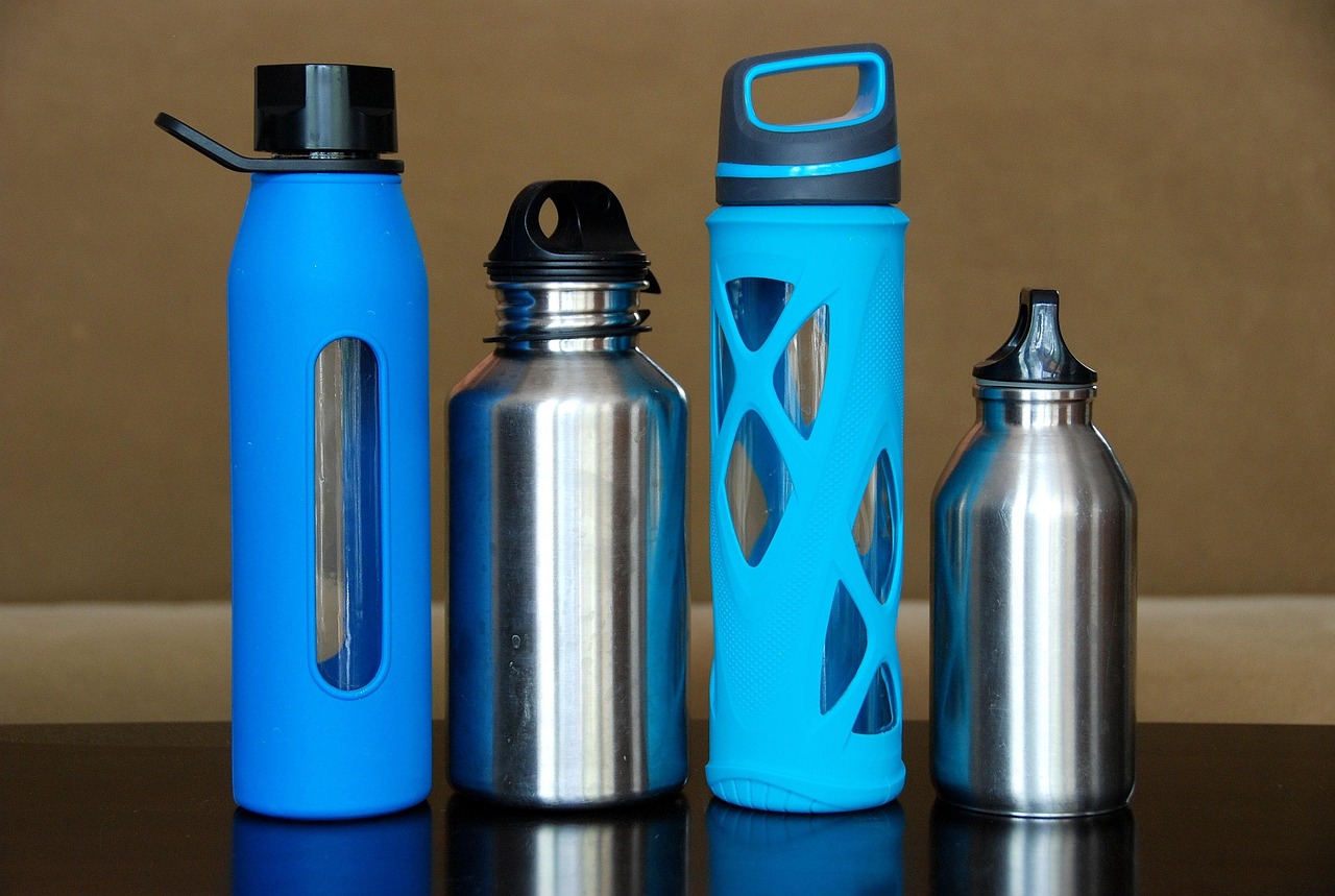 Set of eco-friendly reusable lunch accessories including stainless steel straws and silicone cups