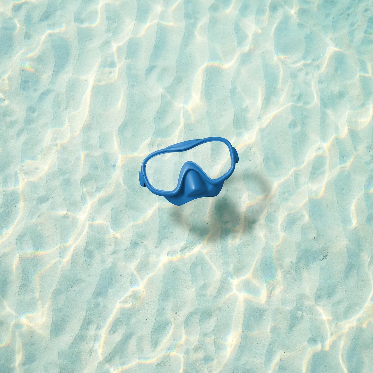 Two people wearing snorkeling gear in a calm shallow lagoon