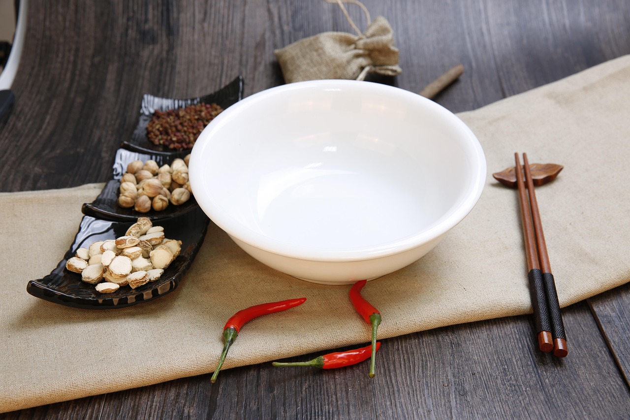 handmade stoneware bowl filled with soup and a spoon on the side