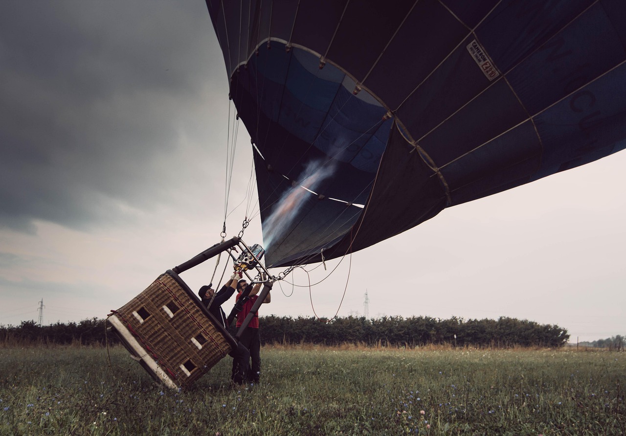 Group of passengers standing in a hot air balloon basket before launch