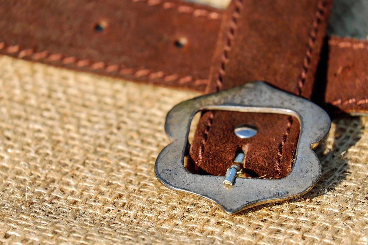 Leather care products including oil and brush on a wooden surface