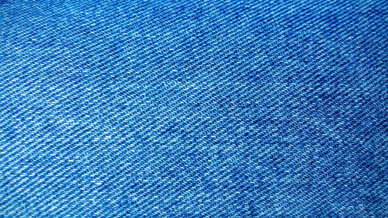 Macro close-up of organic cotton fabric weave showing texture and thread details
