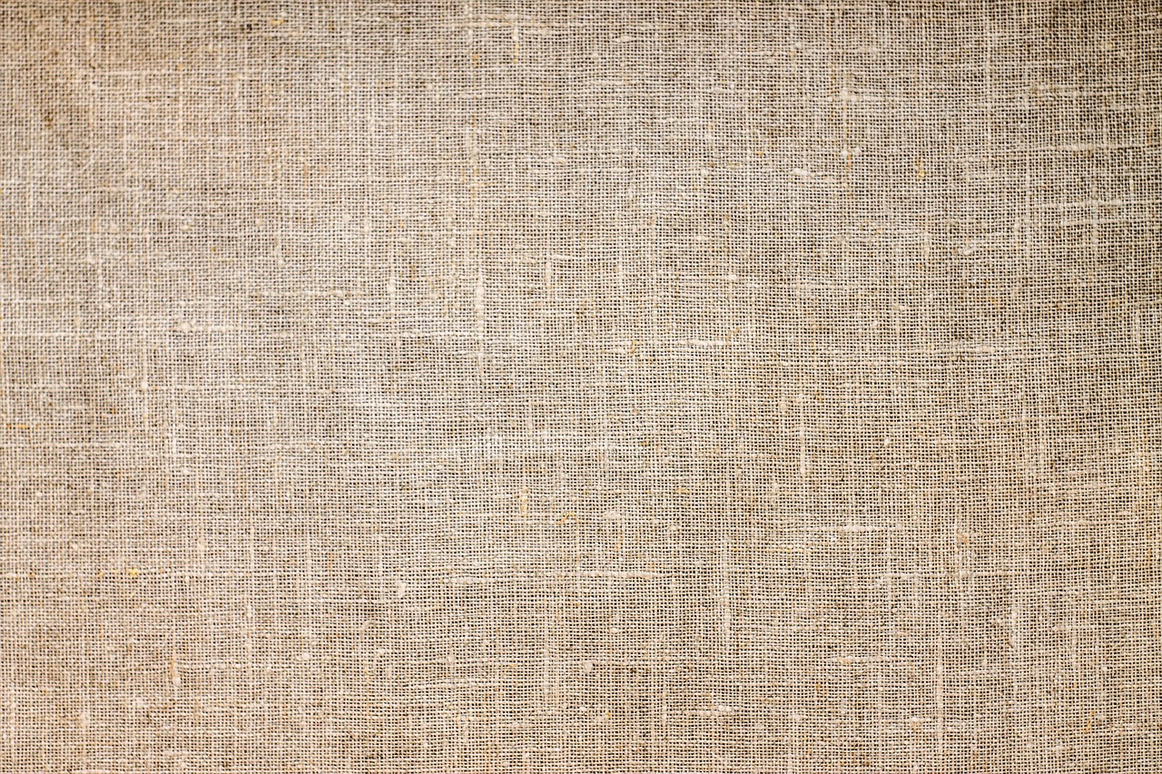 A set of organic jute tote bags displayed on a wooden table