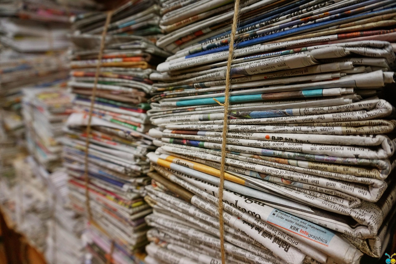 A stack of various eco-friendly journals and notebooks made from recycled paper with different cover materials