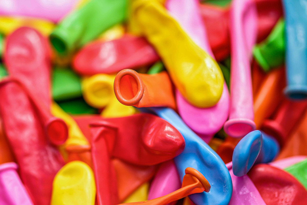 Brightly colored silicone lids stretched over glass mixing bowls in a kitchen