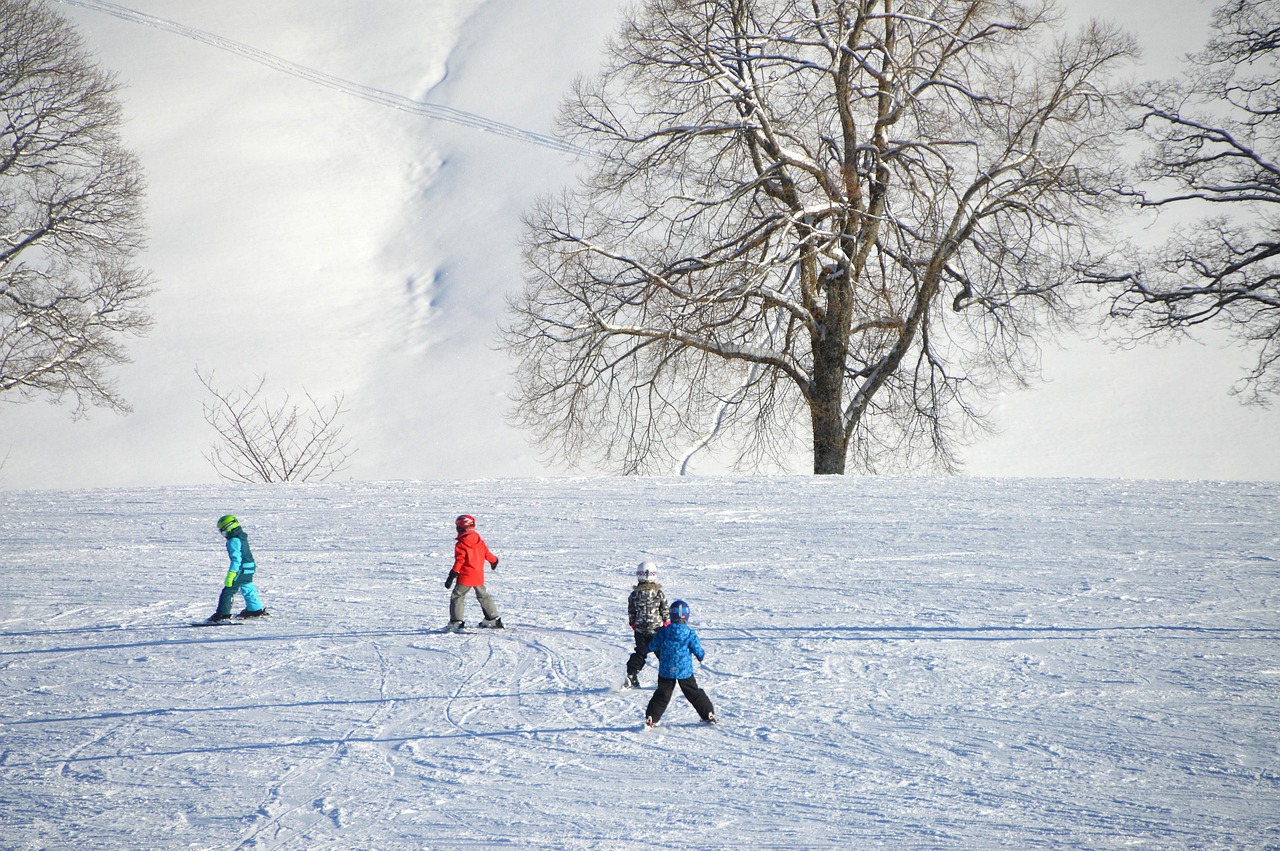 ski lesson on a bunny hill with an instructor helping a beginner
