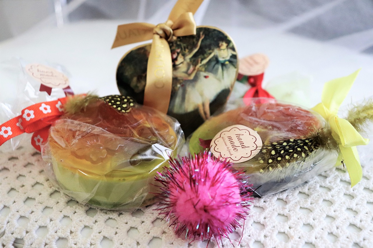Spa gift box containing a fluffy robe, candle, face mask, and journal arranged on a soft surface