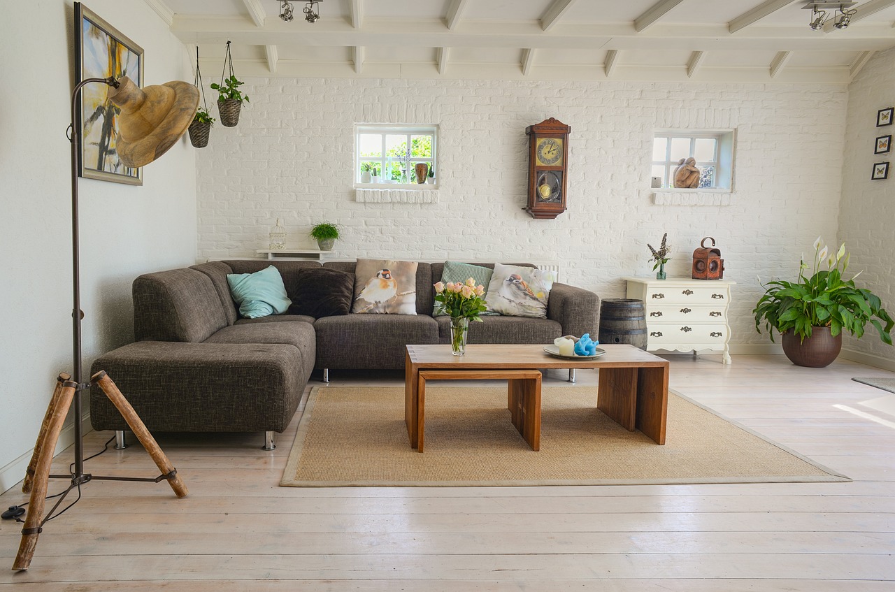 A bright living room featuring sustainable home decor made from natural materials including a rattan chair and bamboo shelving
