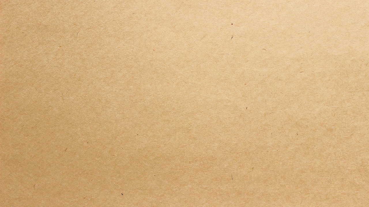 kraft paper gift wrapped with parallel washi tape strips in neutral colors