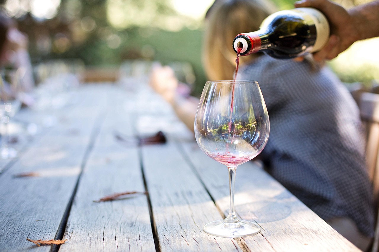 Group of people on a wine tour van ride through a vineyard