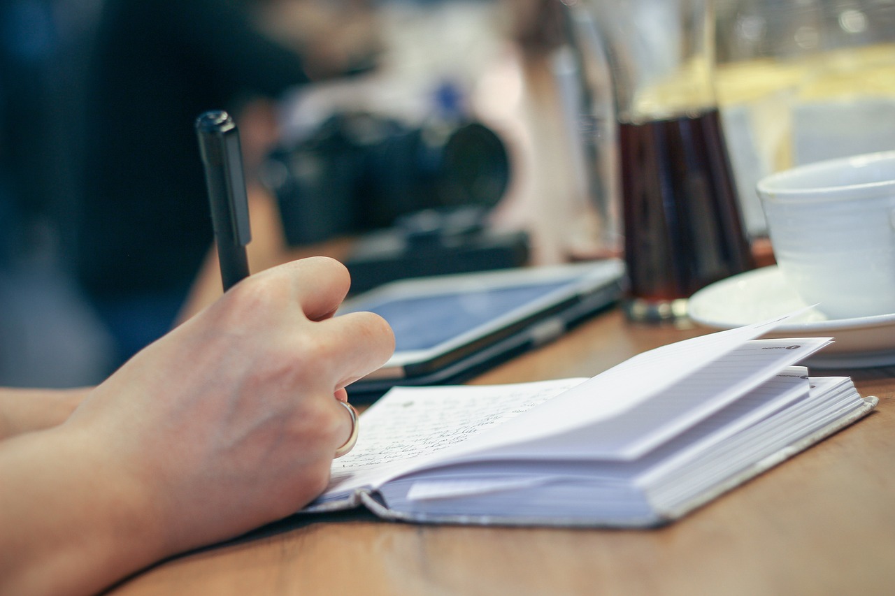 hand, write, pen, notebook, journal, planner, writing, paper, pages, open notebook, notes, desk, person, work, working,
